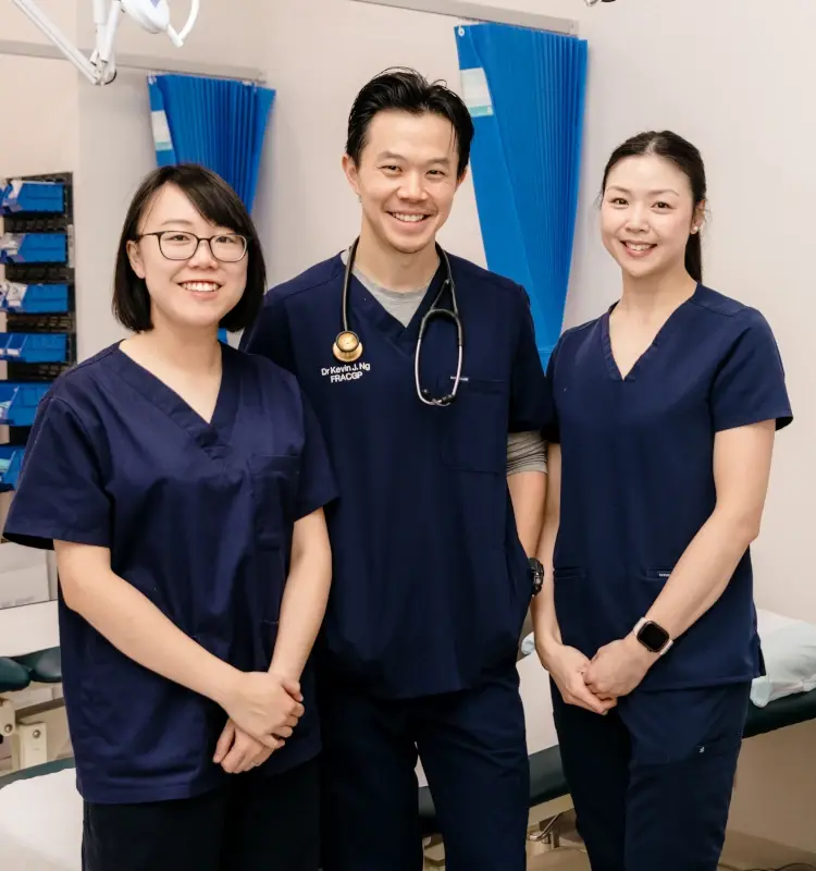 General practitioner and team smiling together in a clinical room